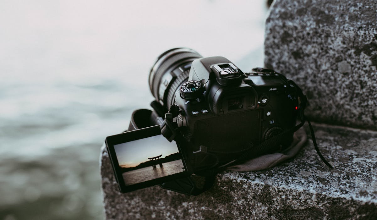 DSLR camera with flip screen near water — hero image for Top 10 Best Cameras Under $500 (2025) by The Tech Ranker